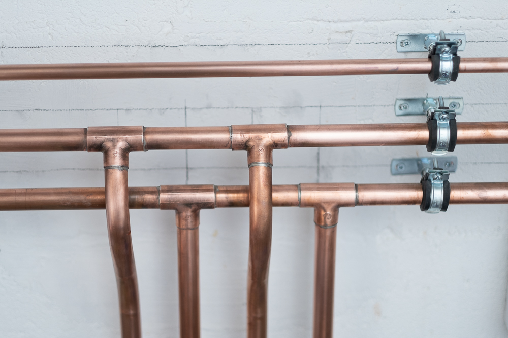 Clipped copper pipe runs